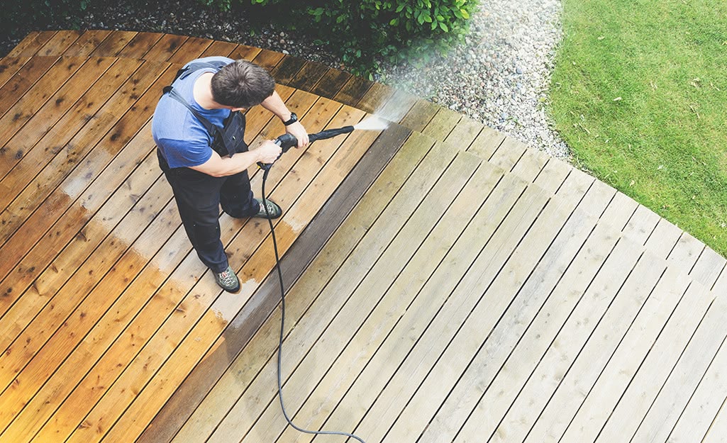 Decking being restored with pressure washer