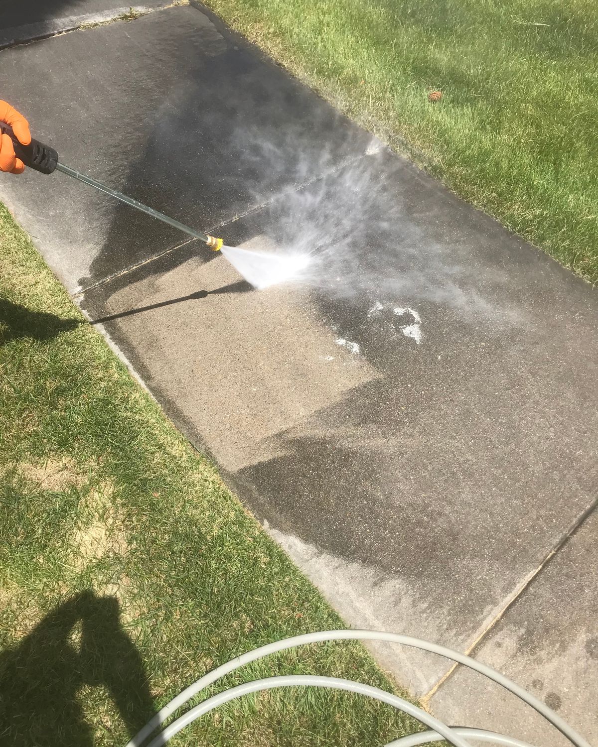 Concrete patio being pressure washed